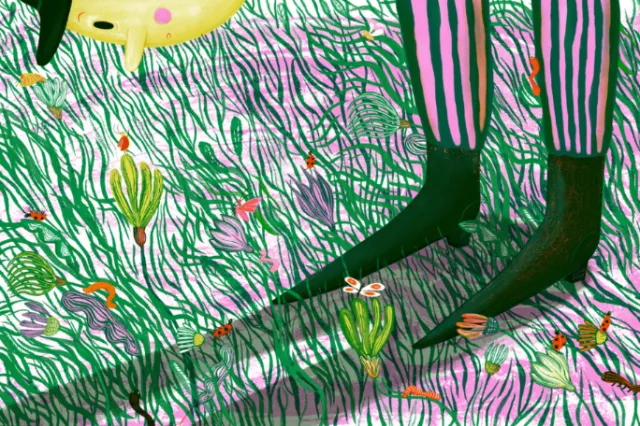 Child's legs in striped pants standing in grass with colorful flowers