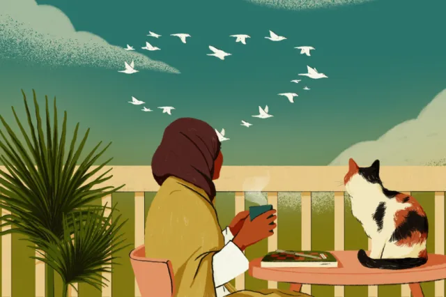 Person in headscarf sitting outdoors with cat and birds flying above.