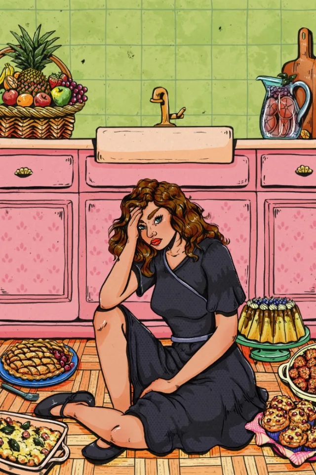 Woman sitting on kitchen floor surrounded by desserts and fruits