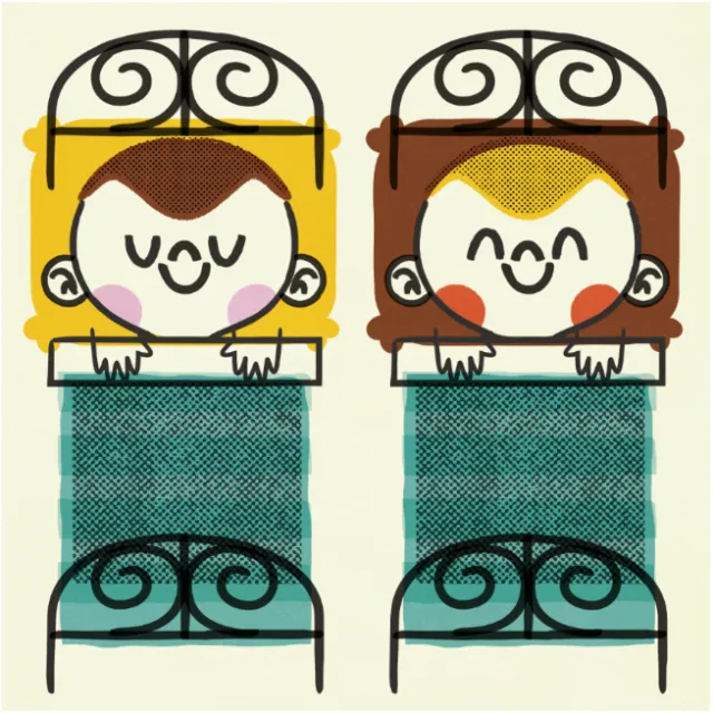 Two smiling children tucked in bed with wrought iron headboards