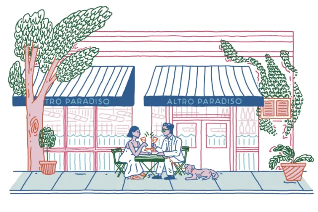 Couple dining outdoors at Altro Paradiso restaurant with a dog nearby