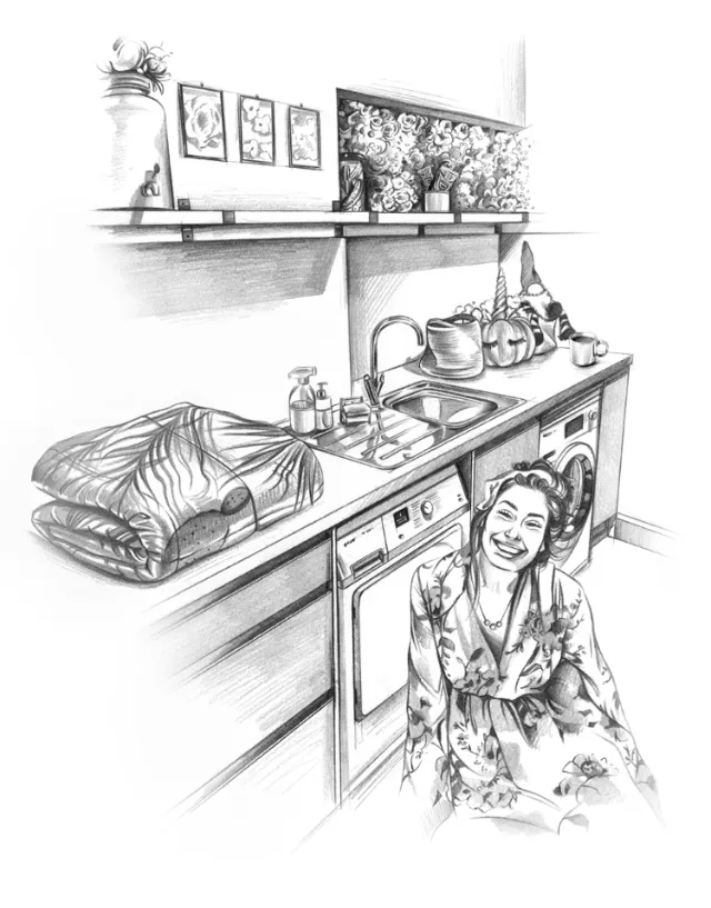 Woman sitting near washing machine with folded clothes on counter