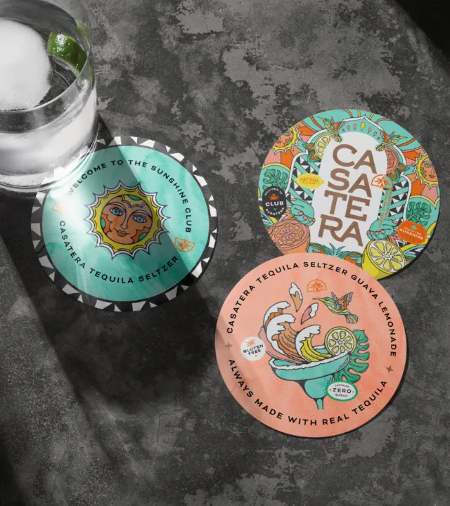 Three Casaterra tequila seltzer caps with vibrant artistic illustrations