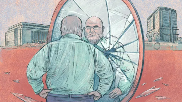 Man looking at cracked mirror reflecting his face outdoors