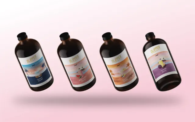 Four brown cocktail bottles with vintage travel poster style labels