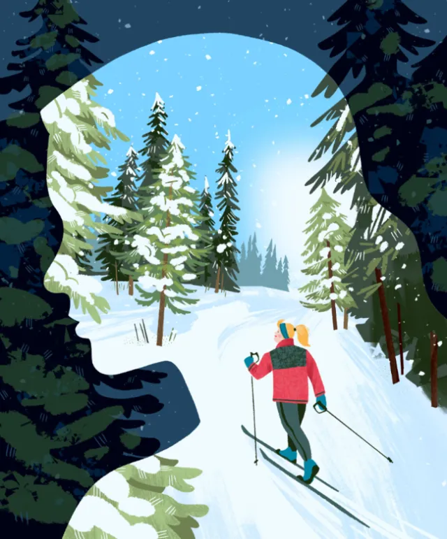 Cross-country skier in snowy forest inside woman's silhouette