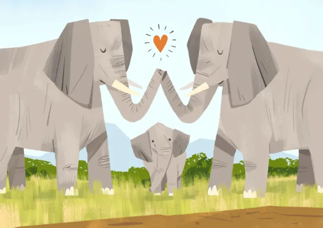 Elephant parents touching trunks over baby elephant in grassland