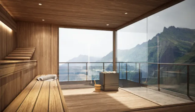 Wooden sauna interior with panoramic mountain view through glass wall