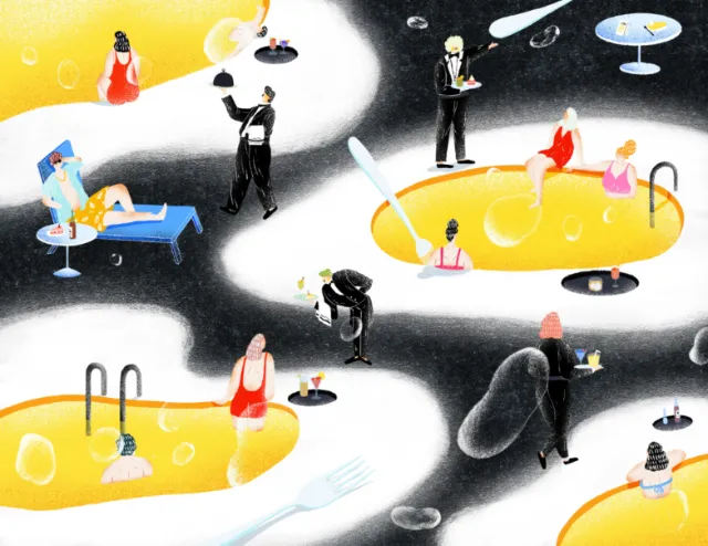 People relaxing in yellow pools with waiters serving drinks