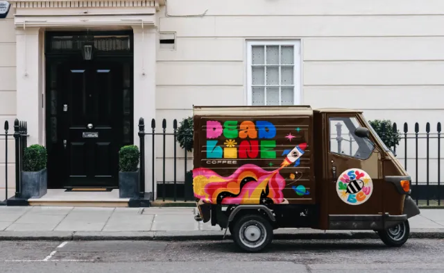 Deadline Coffee delivery truck with vibrant colorful logo and design by Mel Cerri