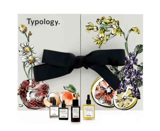 Typology fragrance set with floral artwork and tied with a black bow by Elly Azizian