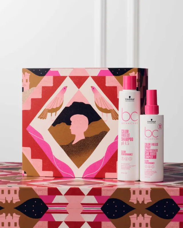 Two pink bottles of hair care products next to a geometric patterned box by Gina Rosas Moncada