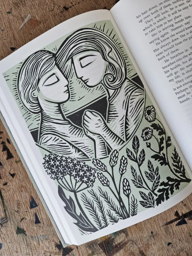Linocut of twins asleep holding hands with herbs and flowers by Becca Thorne
