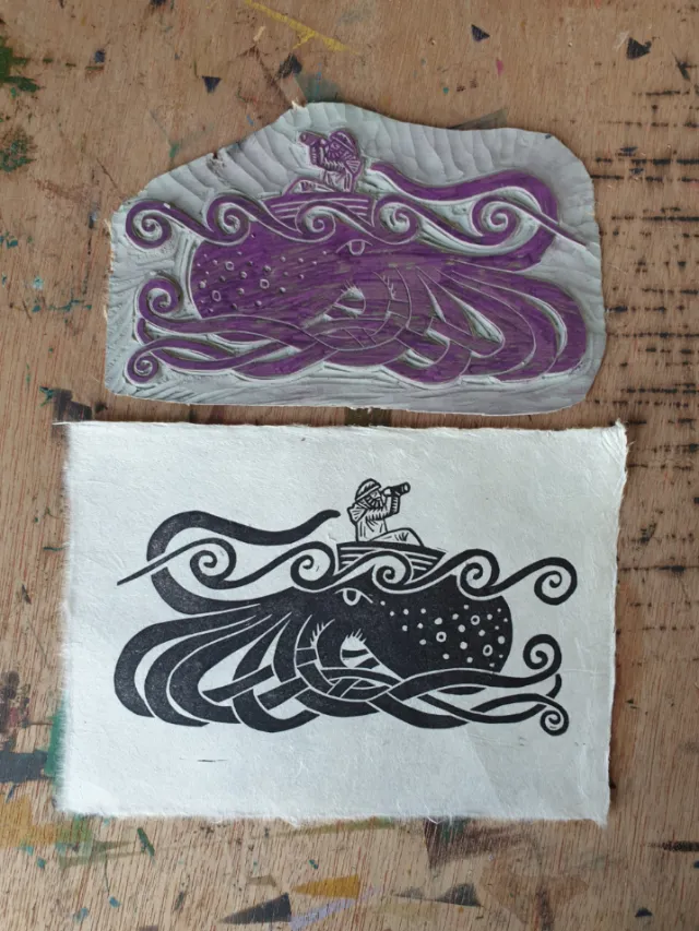 Linocut print and carved block of fisherman on kraken by Becca Thorne