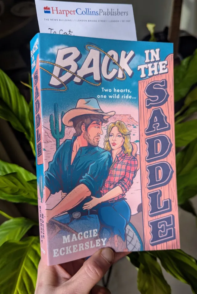 Book cover of Back in the Saddle by Maggie Eckersley, cowboy and woman illustration by Cat Sims