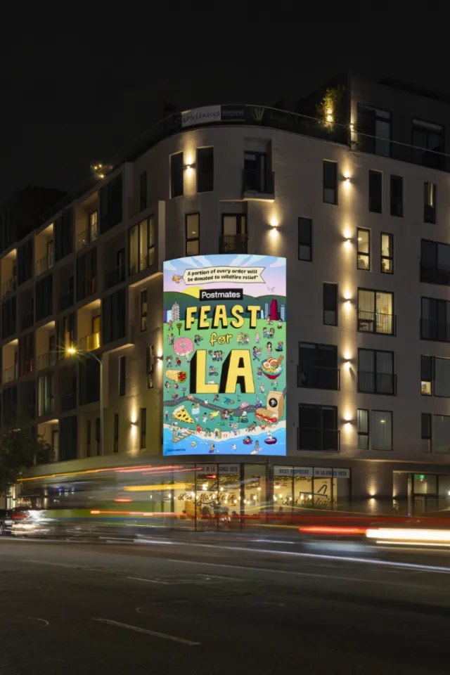 Feast LA banner on city building at night by Daniel Sulzberg