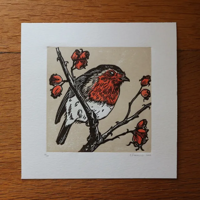 Hand-printed lino cut artwork of a robin and rose hips
