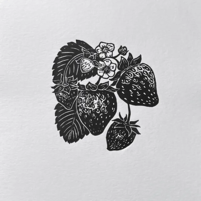 Black and white lino cut print of strawberries and flowers by Emily Robertson
