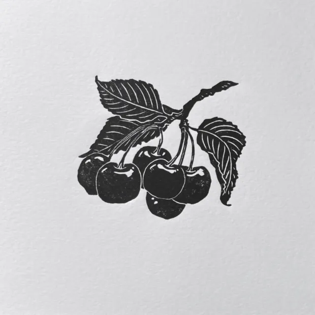 Lino cut print of a cherry sprig with leaves by Emily Robertson