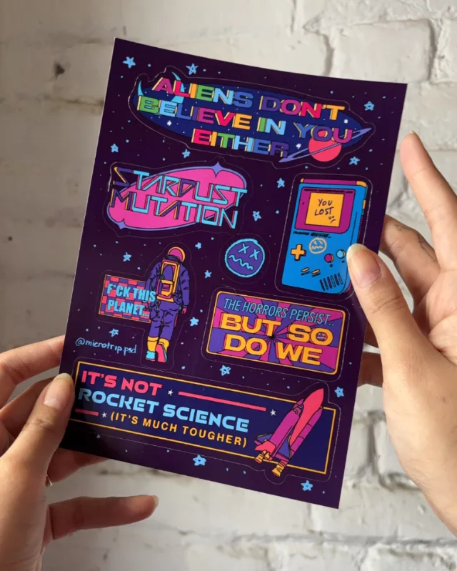 Sci-fi themed sticker sheet with colorful space and alien designs by Tuhina Sharma