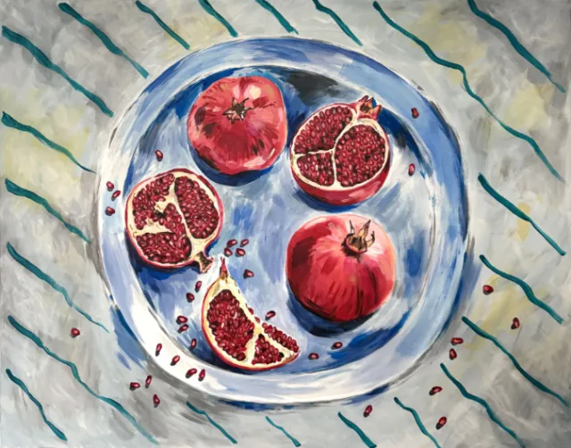 Pomegranates arranged on a blue plate on striped cloth by May van Millingen