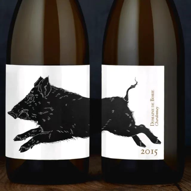 Wine bottle label with lino cut print of a leaping boar by Emily Robertson