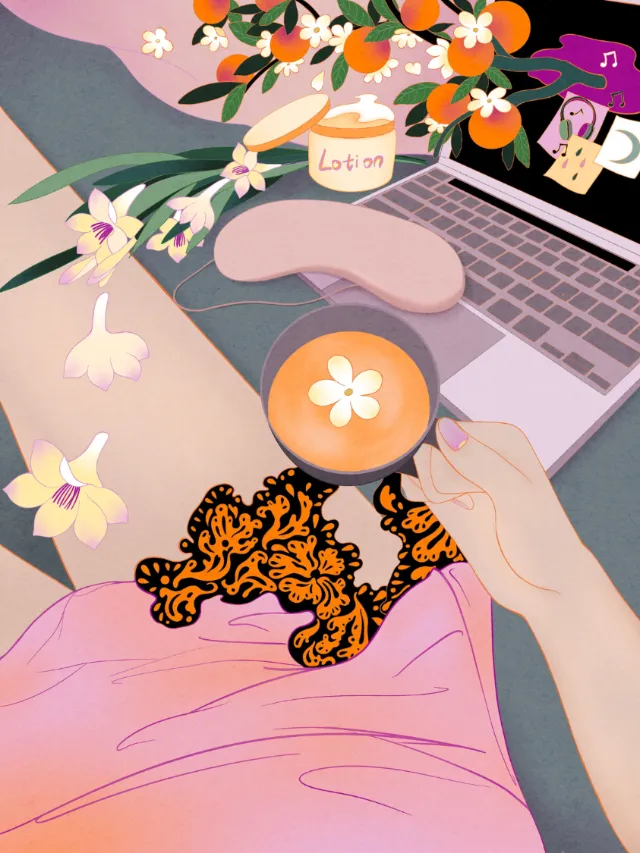 Hand holding coffee cup with flower design near laptop and flowers by Leah Han