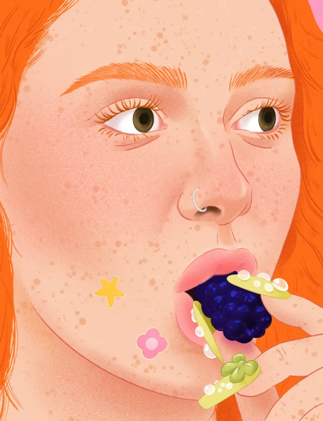 Close-up of a red-haired woman eating blackberries on crackers by Julia Prokhotskaya