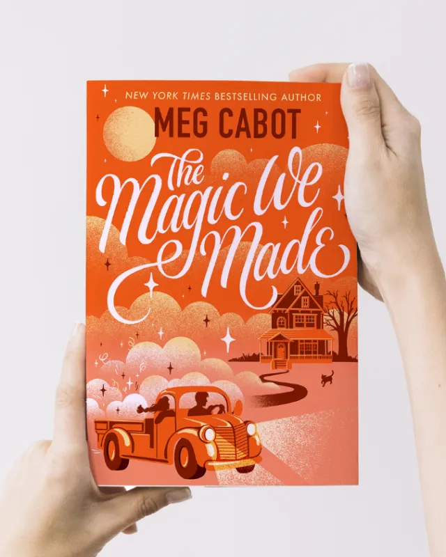 Hands holding The Magic We Made book by Meg Cabot with vintage car and house illustration by Alissan