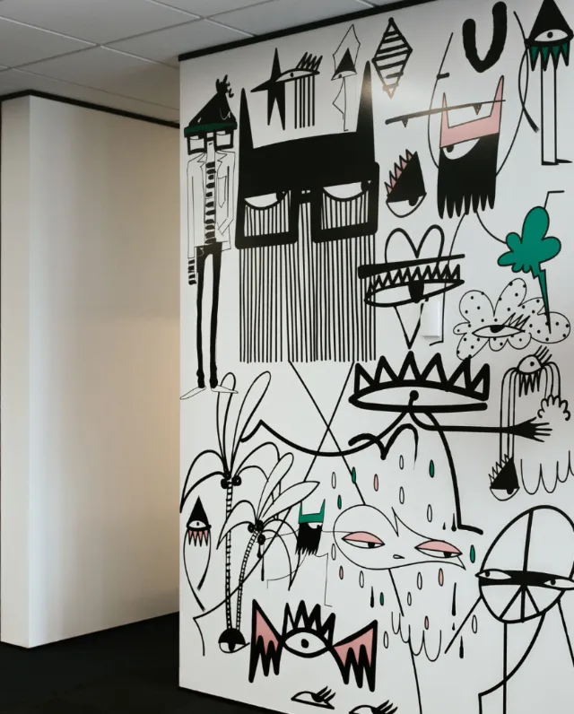 Abstract mural with faces, shapes, and plants by Nadia Flower