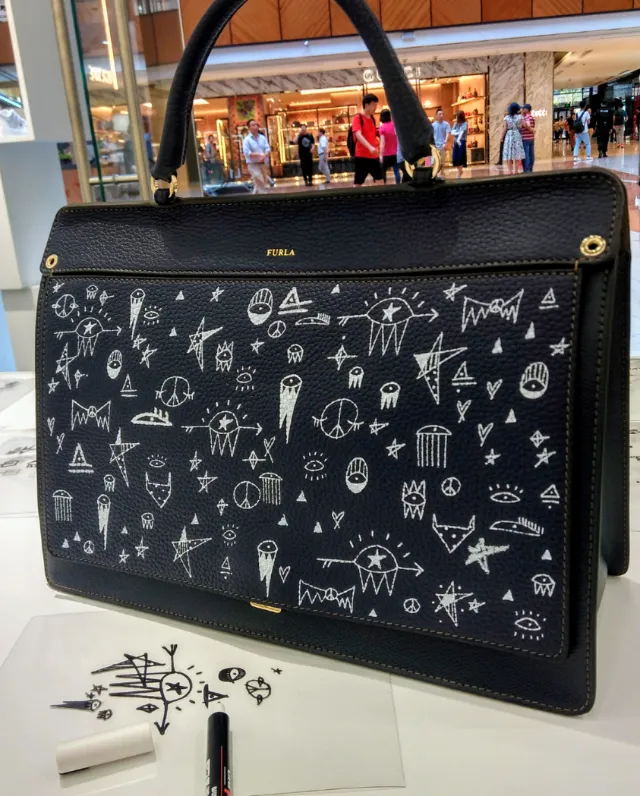 Black Furla handbag with white abstract drawings by Nadia Flower