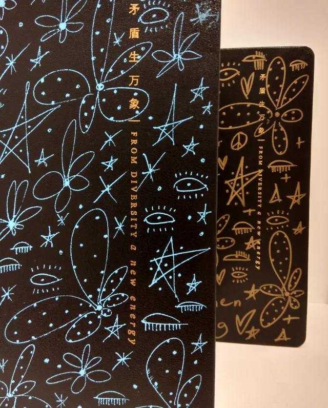 Black notebooks with celestial and floral patterns by Nadia Flower