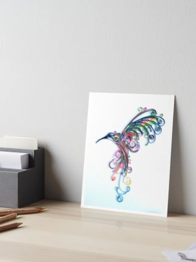 Glimpsecraft artwork of a colorful hummingbird illustration displayed on a desk