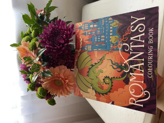 Chrissy Lau's Romantasy Colouring Book beneath a colorful bouquet of flowers