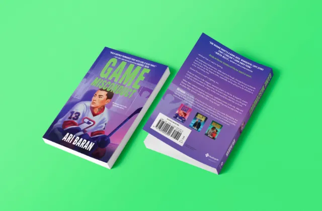 Open purple book photographed by Andrei Nicolescu on a bright green background