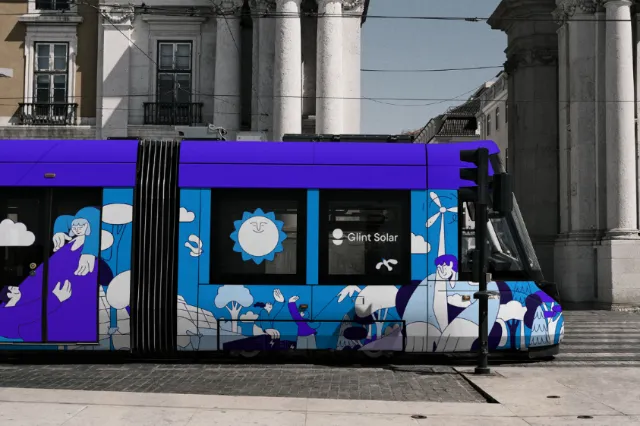 Colorful tram artwork by Joseph Carrington outside a neoclassical building