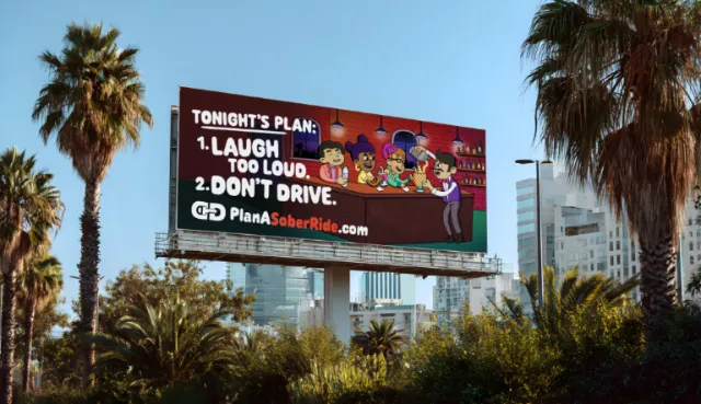 Daniel Sulzberg photograph of a sober ride billboard among palm trees