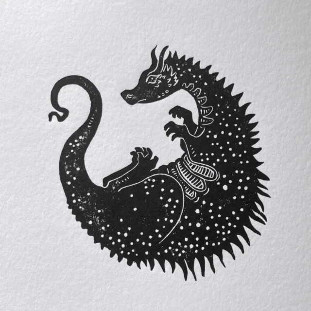 Curled dragon linocut by Emily Robertson