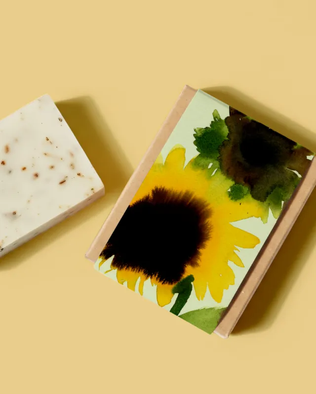Nadia Flower sunflower artwork beside a speckled handmade soap bar