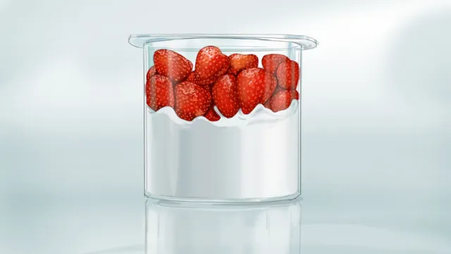 Clear container filled with fresh strawberries by Björn von Schlippe