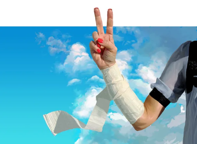 Hand wrapped with paper making a peace sign under blue sky by POW!!!
