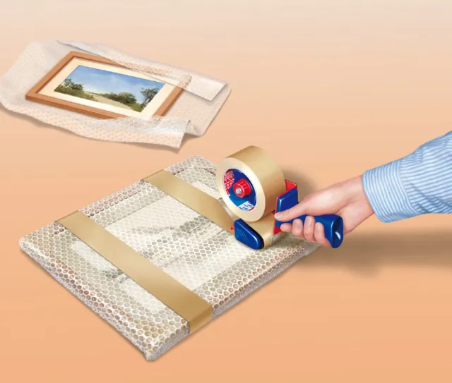 Hand taping bubble wrap around framed picture, artwork packing by Eberhard Reimann