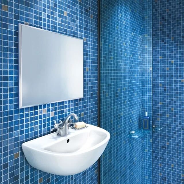 White bathroom sink and faucet with blue mosaic tiles by Eberhard Reimann
