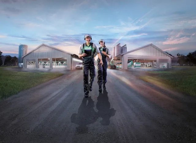 Two workers walking on road near industrial sheds by Tom Krieger
