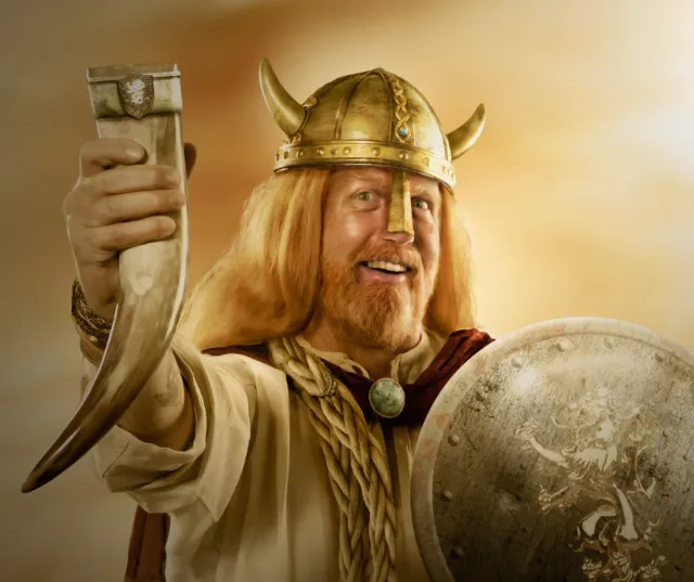 Viking warrior with horned helmet holding a drinking horn and shield by Tom Krieger