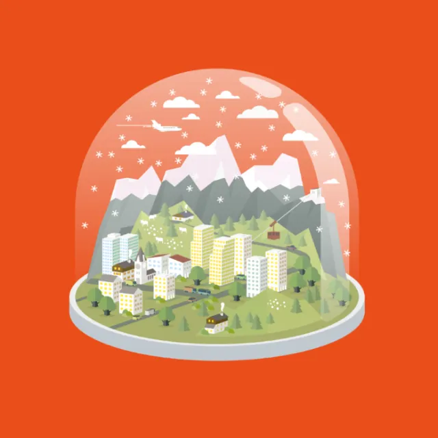 Miniature town with buildings and mountains inside a snow globe by Tobias Wandres